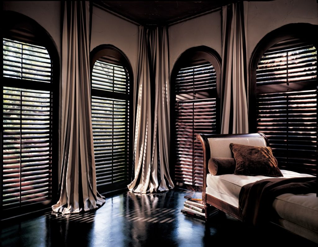 Elegant dark wood blinds custom fit to any size and shape window.