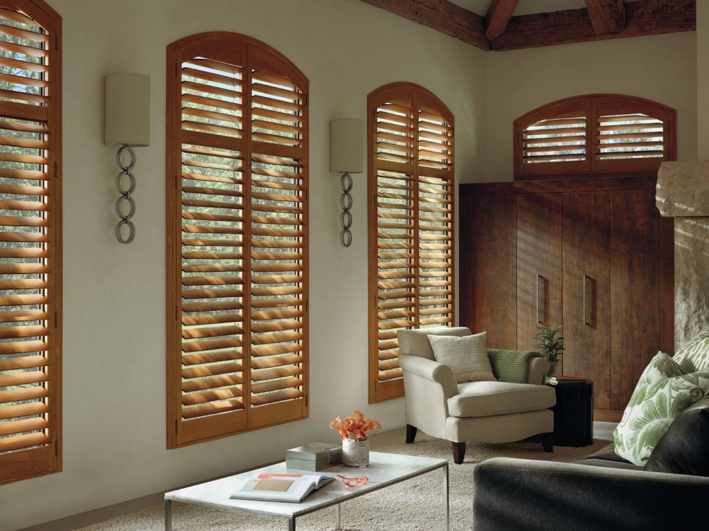 Tall wood shutters to control the light in a reading room.